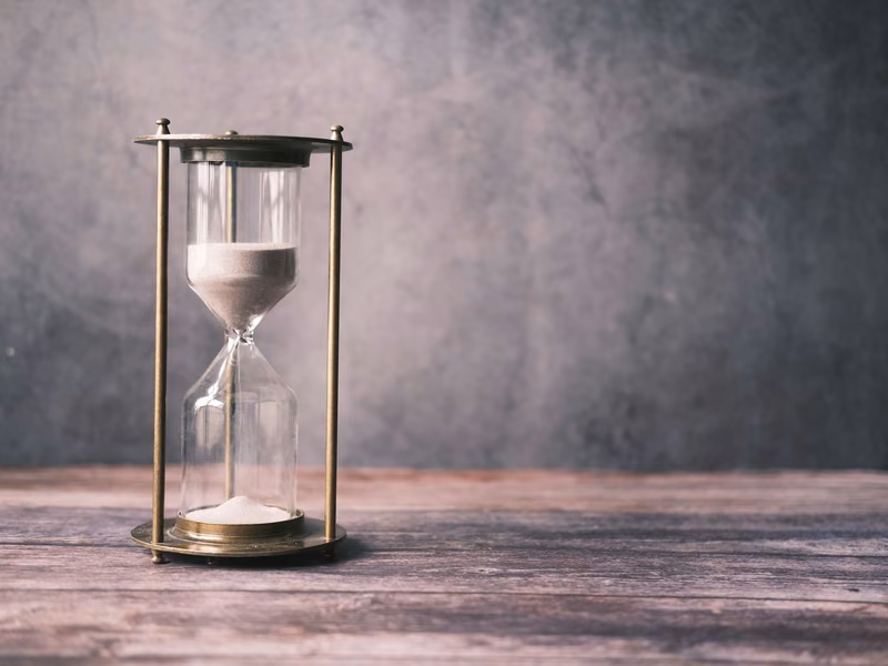 An hourglass with sand running down
