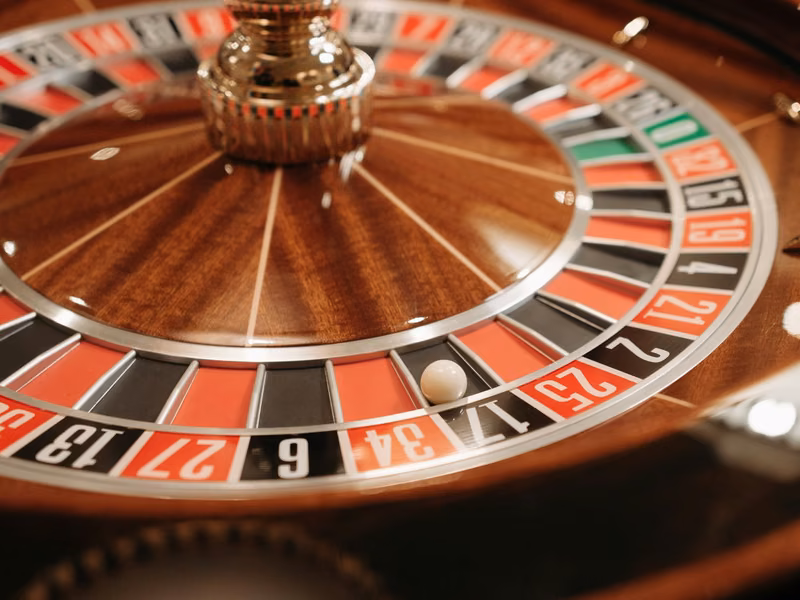 Close-up of a wooden roulette wheel with red and black pockets